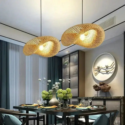 Two vintage golden bamboo led pendant lights with handcrafted weave hang above a dining table for ambient lighting
