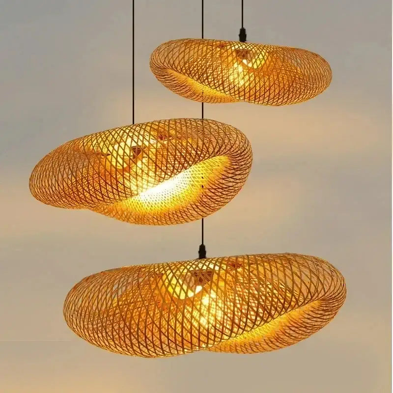 Three golden woven bamboo led pendant lights with a warm glow handcrafted for dining room use