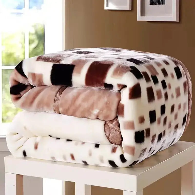 A plush vintage gray double layered raschel blanket with cream base and geometric brown black beige squares pattern
