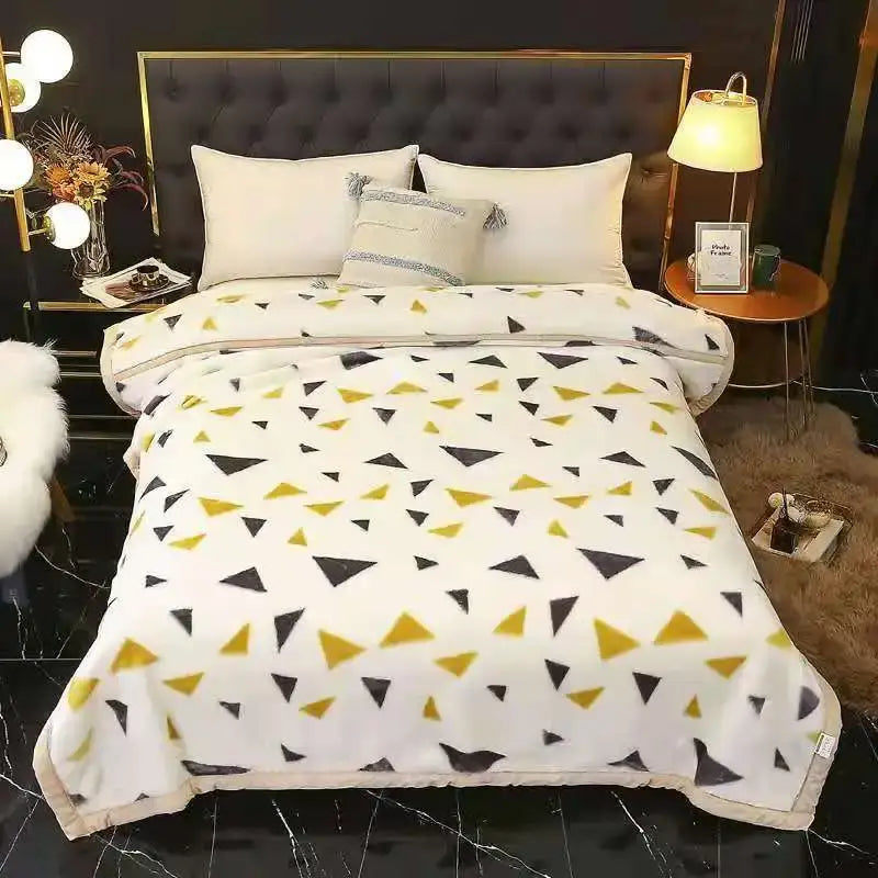 A cozy white fleece double layered raschel blanket with black and mustard-yellow triangles, vintage plush throw