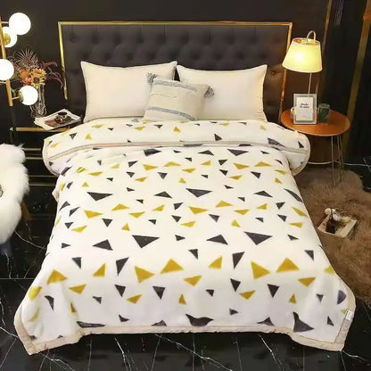 A cozy white fleece double layered raschel blanket with black and mustard-yellow triangles, vintage plush throw