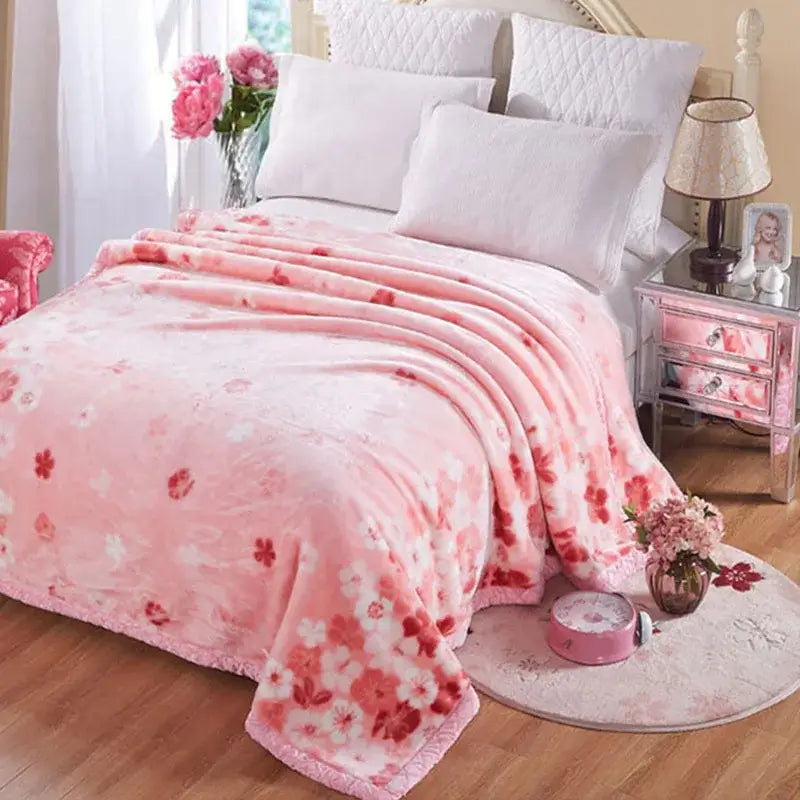 Pink floral throw blanket with plush texture and fringed edges in a vintage gray double layered raschel style