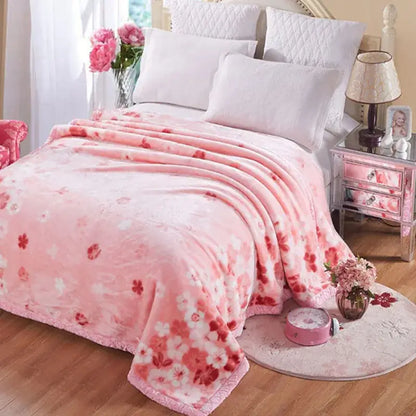 Pink floral throw blanket with plush texture and fringed edges in a vintage gray double layered raschel style
