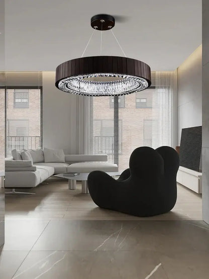 Black circular pendant light with clear crystal accents in gray glass large ceiling design for stairwell lobby