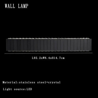 Modern black wall lamp with stainless steel and crystal accents shown alongside vintage gray glass large ceiling pendant light