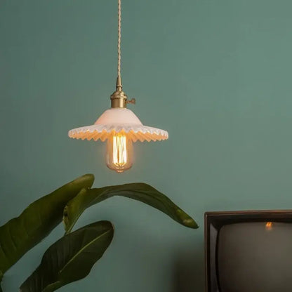 Vintage off-white ceramic pendant light with scalloped edge and brass glass led featuring exposed filament bulb
