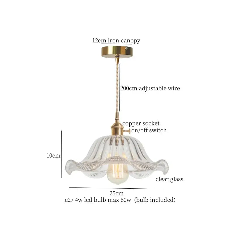 A delicate clear glass pendant light with green brass glass led components and a fluted petal design for kitchen use