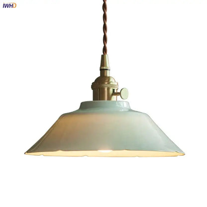 Vintage green ceramic pendant light with matte blue shade, brass hardware, and twisted brown cord for kitchen use