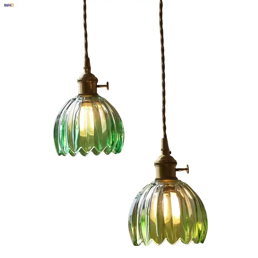 Two vintage green glass led pendant lights with brass fixtures and twisted cords for kitchen use
