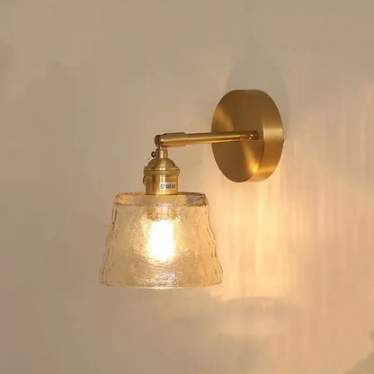 A warm-toned brass wall sconce with textured amber glass shade for vintage green glass led wall lights bedroom sconce with pull chain