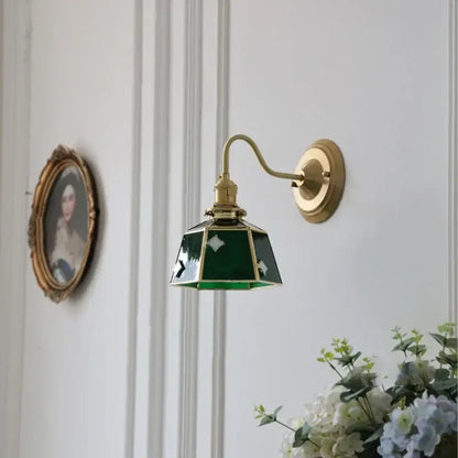 Vintage green glass led wall sconce with brass hardware and curved arm for stair lighting use