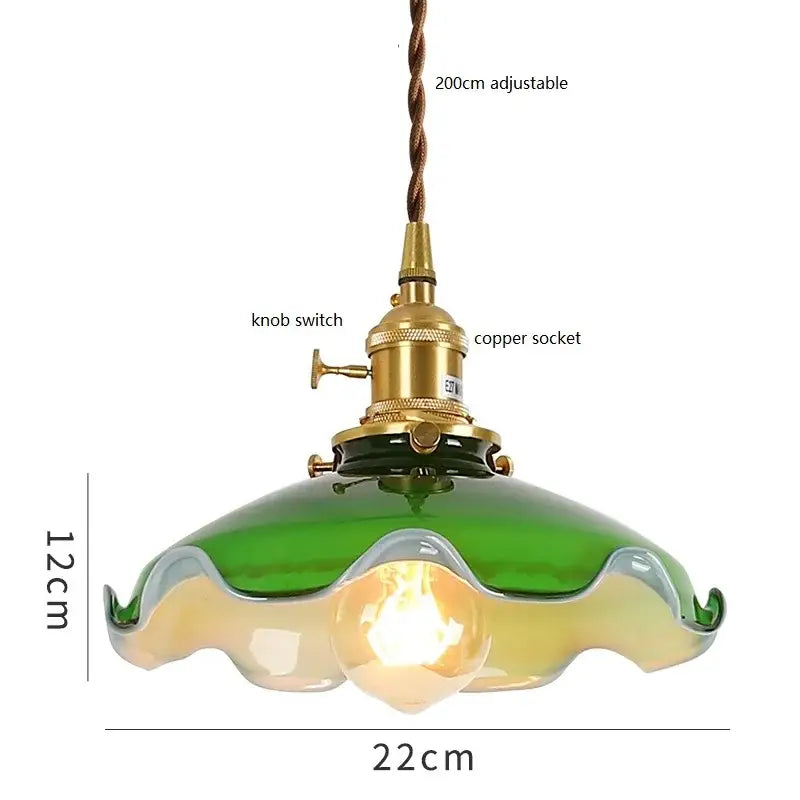 Vintage green glass pendant lamp with cream accents and brass hardware featuring a copper socket and knob switch