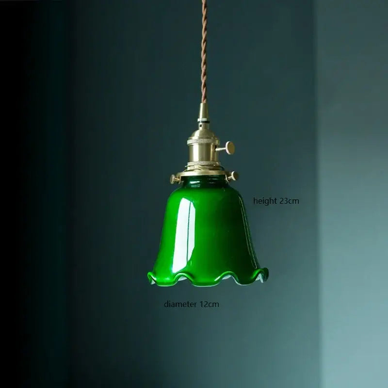 Glossy emerald green vintage pendant lamp with bell-shaped glass, brass hardware, and twisted brown cord for kitchen lighting
