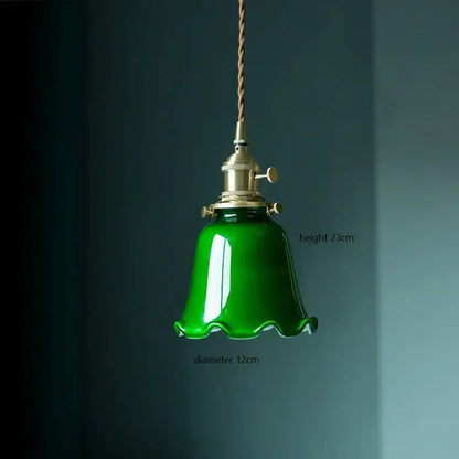 Glossy emerald green vintage pendant lamp with bell-shaped glass, brass hardware, and twisted brown cord for kitchen lighting