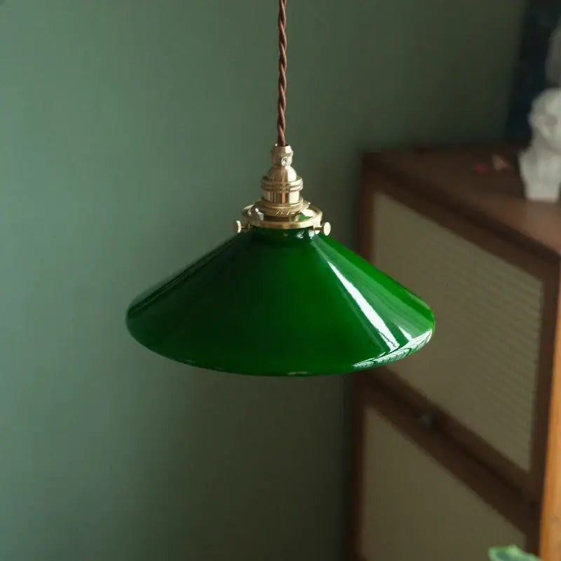 Glossy emerald green glass vintage pendant lamp with brass hardware and twisted brown cord for kitchen lighting