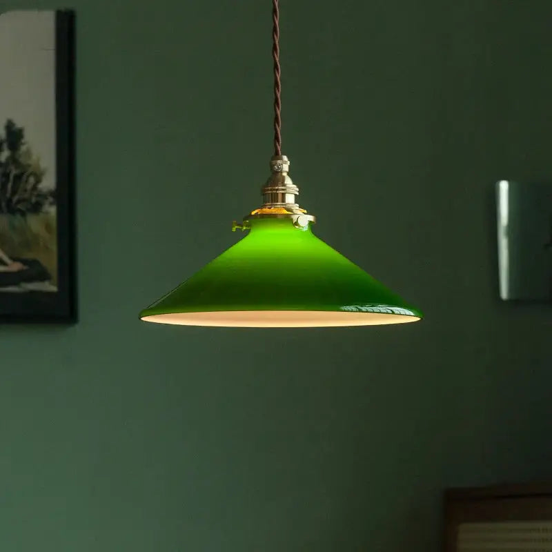 Vintage green glass pendant lamp with brass hardware and braided cord featuring a vibrant enamel pendant lamp design