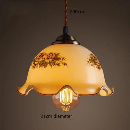 Warm amber glass vintage pendant lamp with delicate floral patterns and scalloped edge for kitchen use brass hardware