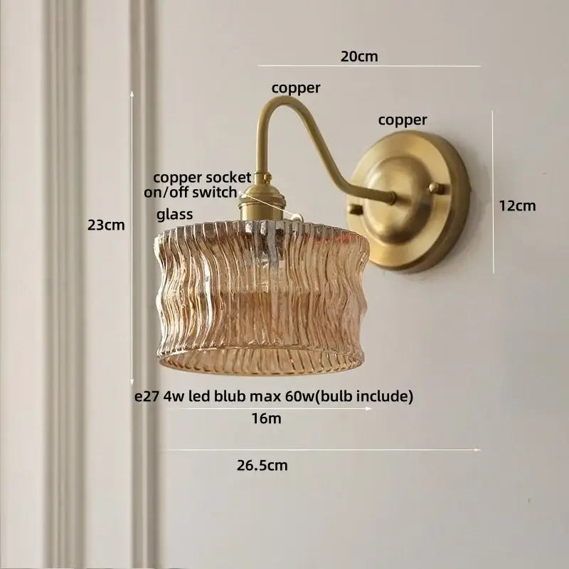 Antique brass-finished copper wall light with textured amber glass shade and copper knob switch for bedroom use