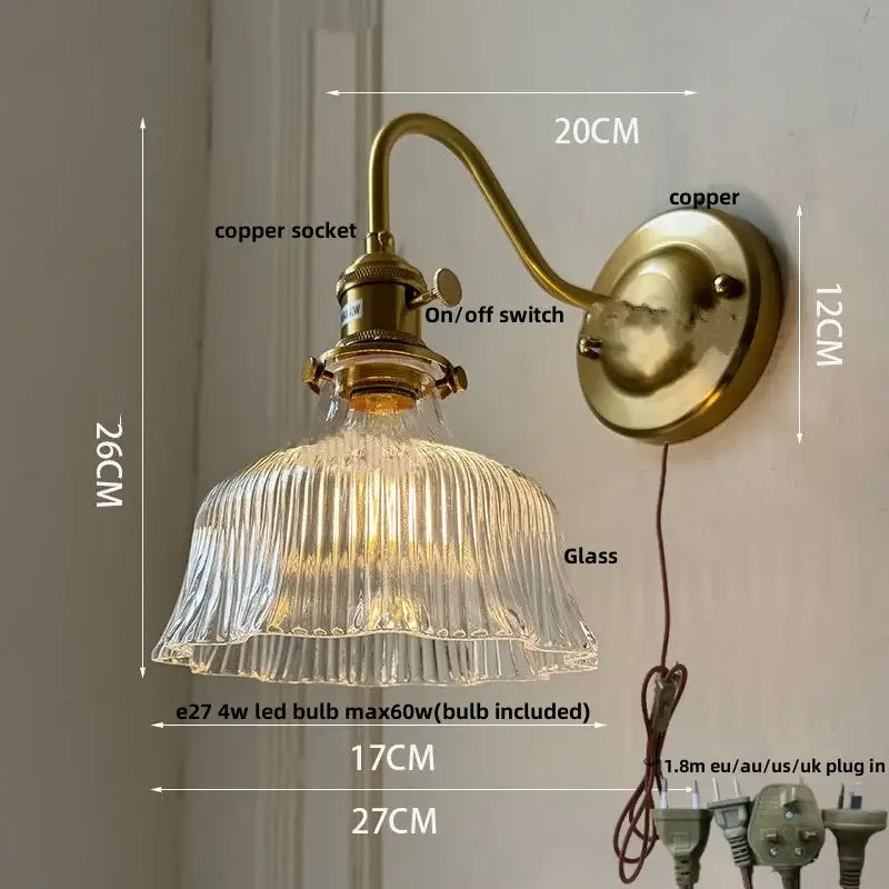 Vintage-style brass wall light with ribbed green glass shade and copper knob switch for bedroom lighting