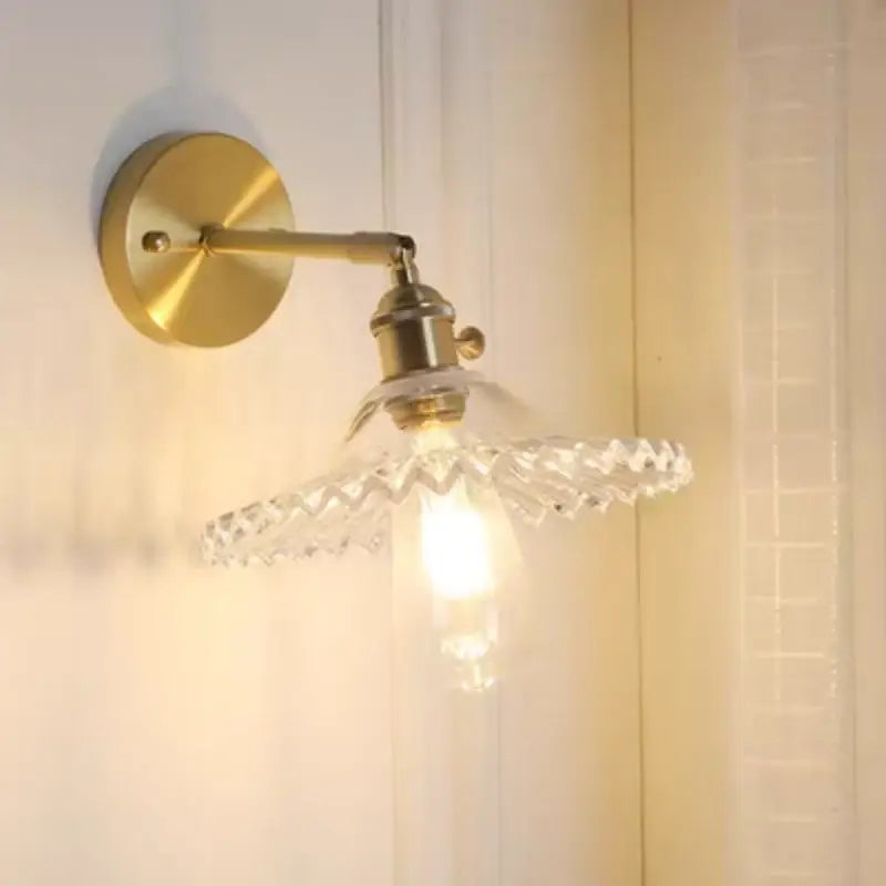 Vintage green glass wall light with brass wall sconce and clear faceted glass shade featuring pull chain switch