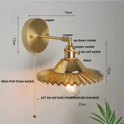Vintage green glass wall light with brass-finished copper hardware and fluted shade featuring pull chain switch for bedroom use
