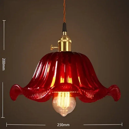 A vibrant red vintage glass pendant light with brass fixture and exposed bulb for cafe and restaurant lighting