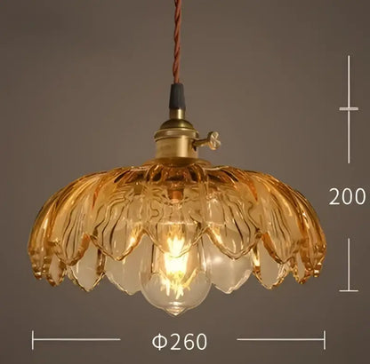 Vintage hand blown glass pendant light with golden glass and brass fixture featuring an exposed bulb for living room use
