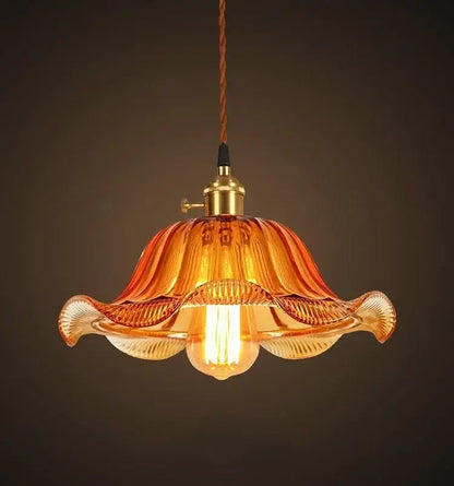 Vintage hand blown glass pendant lights featuring a warm amber fluted glass pendant with brass hardware for living rooms