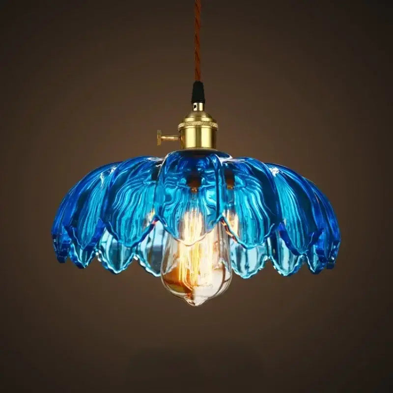 Vintage blue glass pendant lights with brass fixture and exposed filament bulb for elegant living room lighting