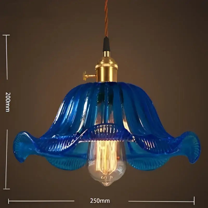 Vintage blue glass pendant lights featuring hand blown glass with a brass fixture and exposed filament bulb for living room