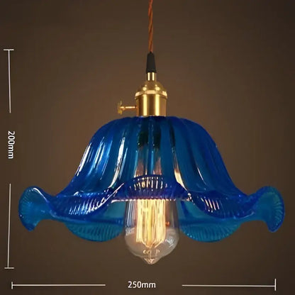 Vintage blue glass pendant lights featuring hand blown glass with a brass fixture and exposed filament bulb for living room