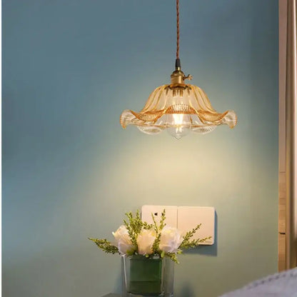 Vintage hand blown glass pendant lights featuring a golden brass frame and delicate translucent glass pendant for living room