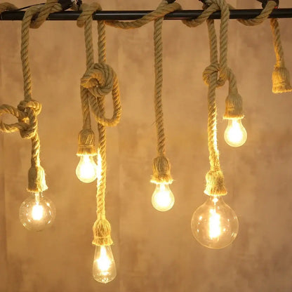 Rustic vintage hemp rope pendant light with warm glowing glass bulbs and thick natural twine for focused lighting