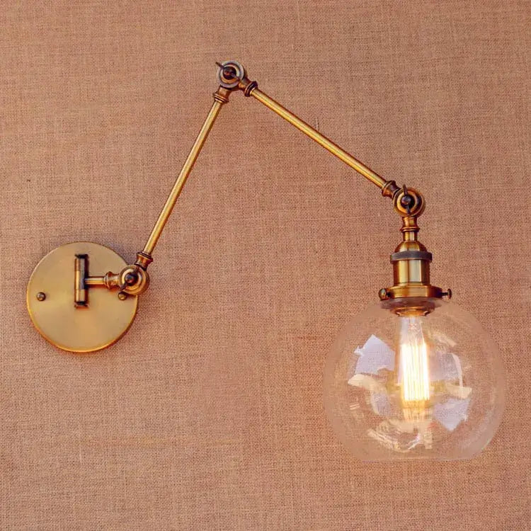 Vintage industrial brass glass ball swing arm light bedroom sconce with adjustable brass glass and clear globe bulb housing