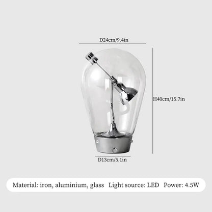 A sleek decorbites glass desk lamp with transparent glass shade and metallic iron aluminum base for vintage industrial decor