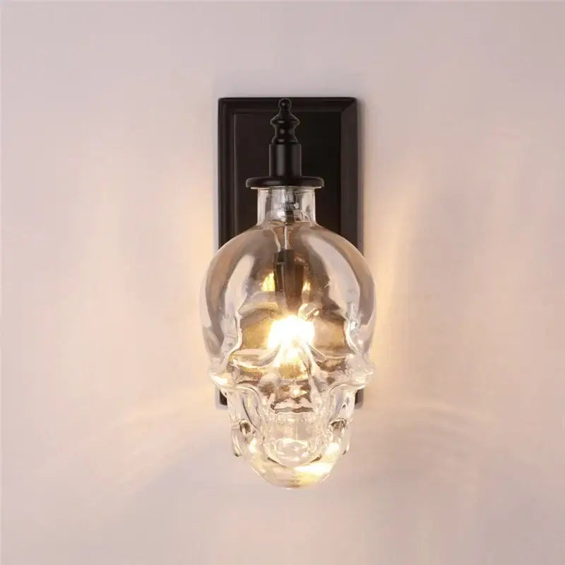 Vintage industrial clear glass skull wall sconce with black metal mounting plate for living room lighting