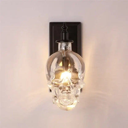 Vintage industrial clear glass skull wall sconce with black metal mounting plate for living room lighting