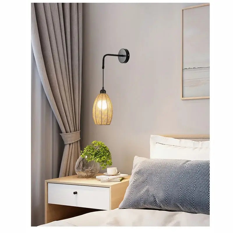 A warm-toned woven rattan wall lamp with black metal arm featuring decorbites industrial hemp rope sconce design