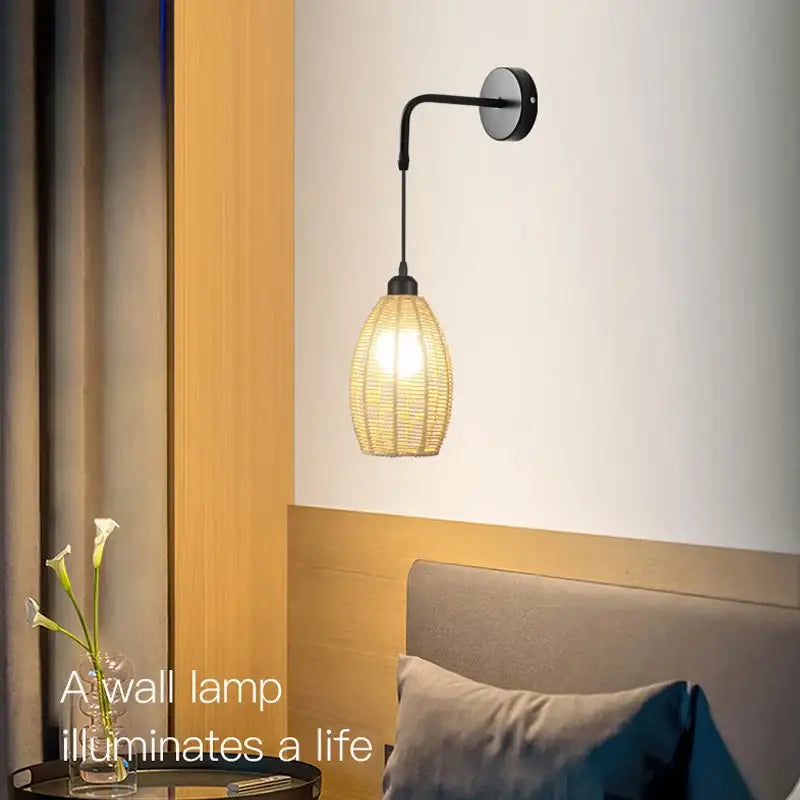 A warm-toned woven rattan wall lamp with sleek black metal arm featuring industrial hemp rope decorbites design