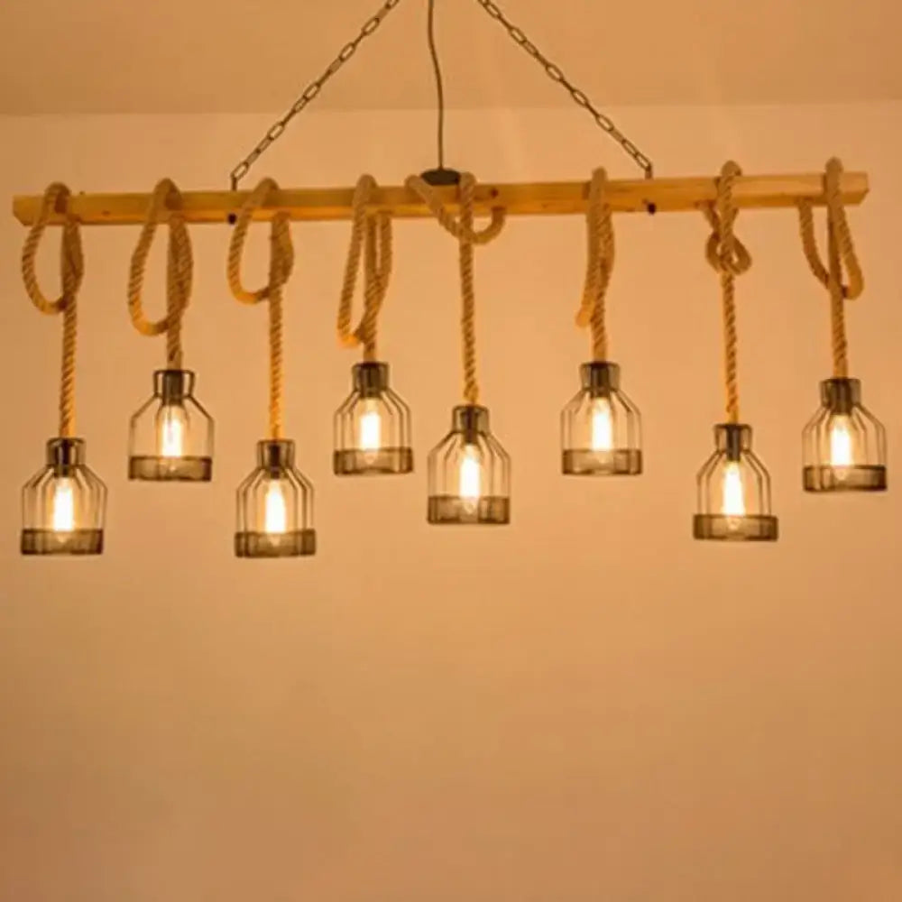 Rustic wooden beam island lighting fixture with six glass bottle shades suspended by rope and metal chains in black