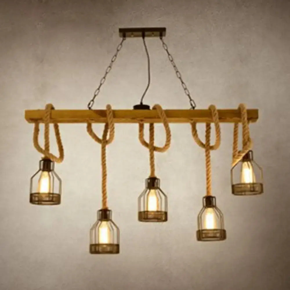 Rustic wooden beam island lighting fixture with thick beige rope suspending five glass bottle bulbs in black finish