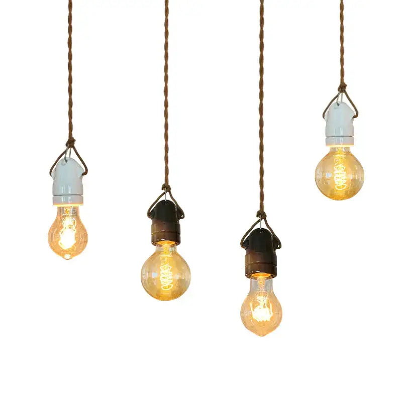 Four vintage-style warm glowing filament pendant lights hang from twisted brown cords for decorbites ceramic led pendant