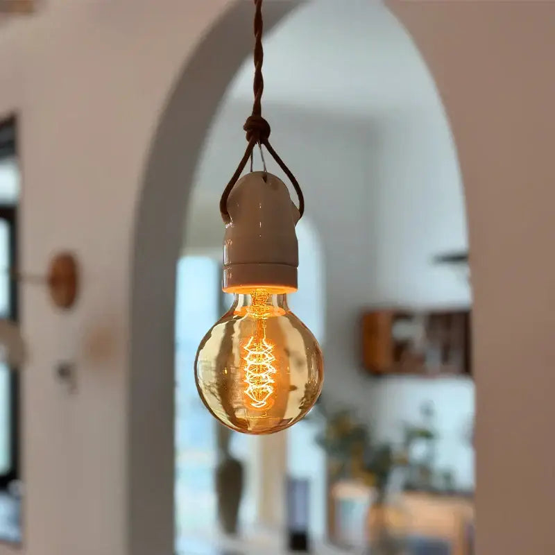 Warm-toned glass bulb ceramic led pendant light with braided cord and off-white vintage japanese ceramic base