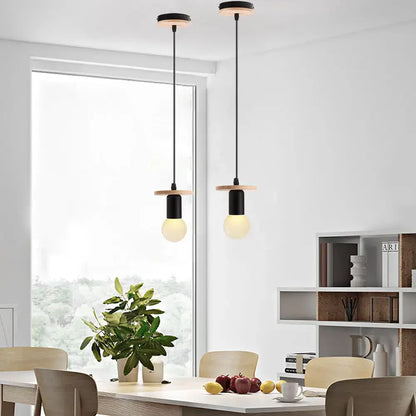 Two minimalist pendant lights with black cylindrical shades and light wood accents for led wood ceiling decorbites pendant light