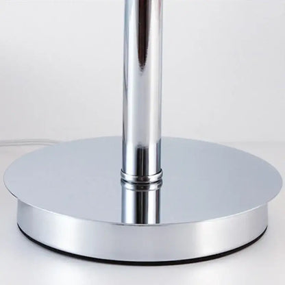 Vintage table lamp with chrome finished cylindrical stem and circular platform base for bedroom lighting