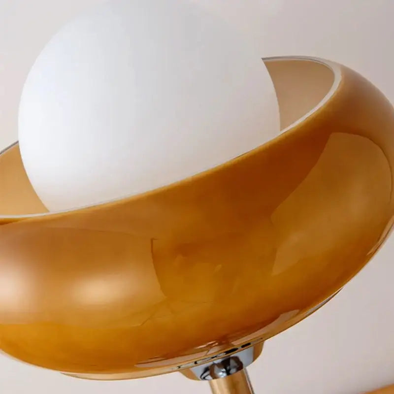 Vintage table lamp with a sleek amber glass shade and white bulb for elegant bedroom lighting and decor