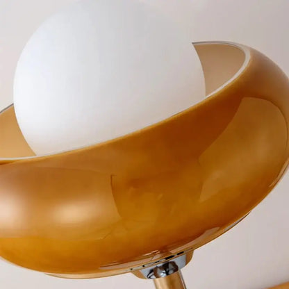 Vintage table lamp with a sleek amber glass shade and white bulb for elegant bedroom lighting and decor