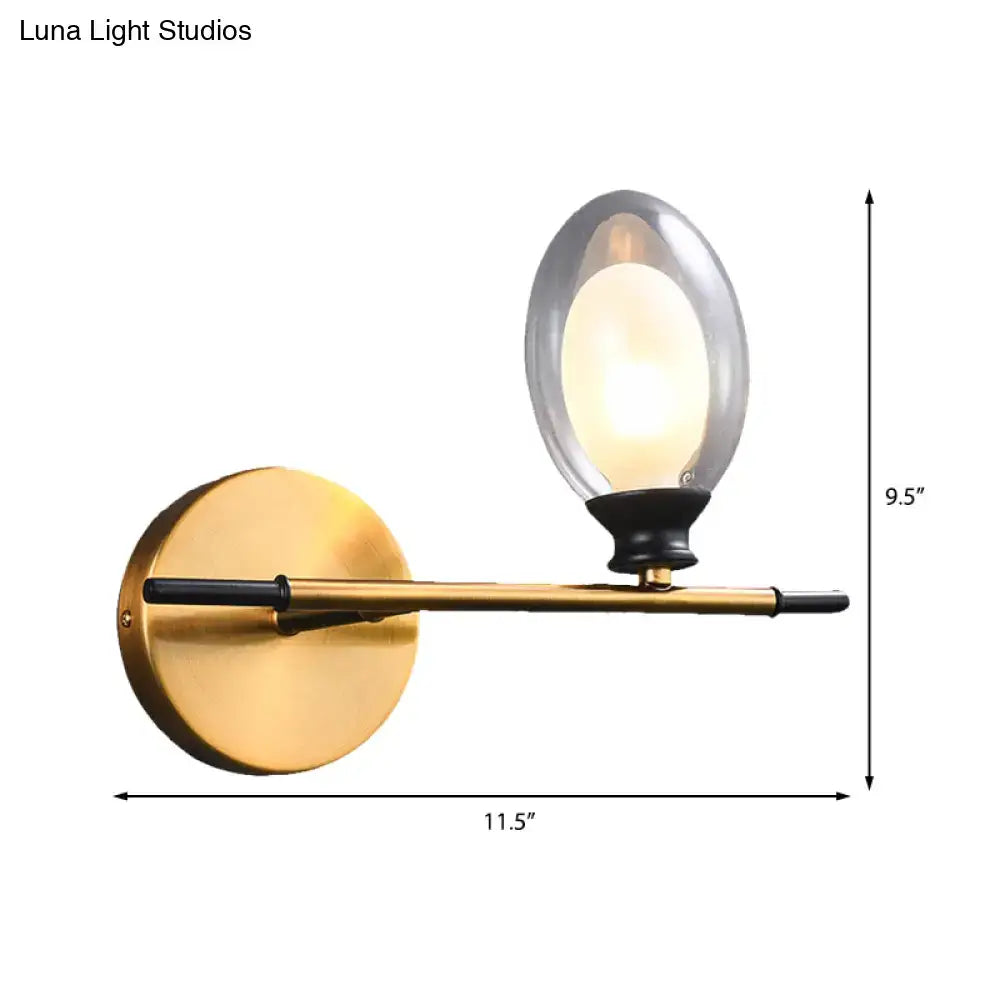 Vintage oval wall sconce with gold-toned brass finish, black accents, and an oval glass shade for bedroom lighting
