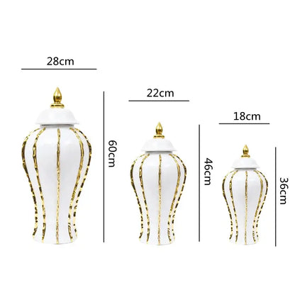 Three elegant vintage porcelain vases with gold rim detailing and lids featuring a fluted design for living room decor