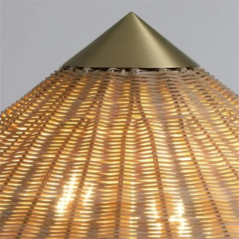 Vintage floor lamp with golden brass cone gubi rattan shade and woven natural rattan body for living room decorbites use